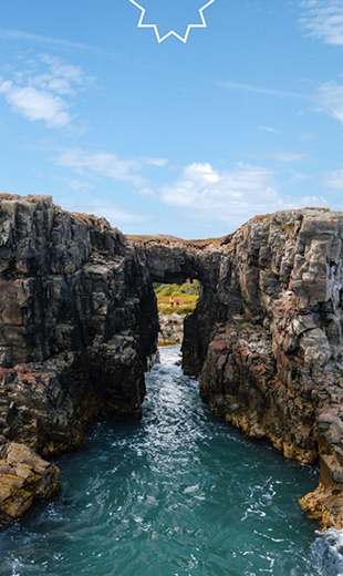 Travellers can be seen through the eroded rocks in Little Catalina. 